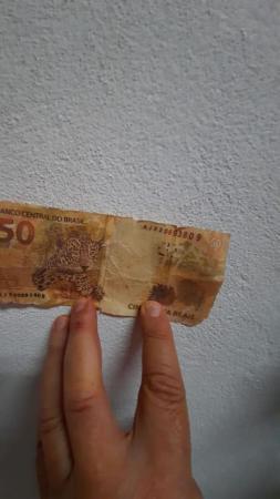 Os papeis, sem valor, imitam notas já com um longo uso, apresentando rasgos e situação que tenta simular uma nota mais velha. - Foto: Reprodução